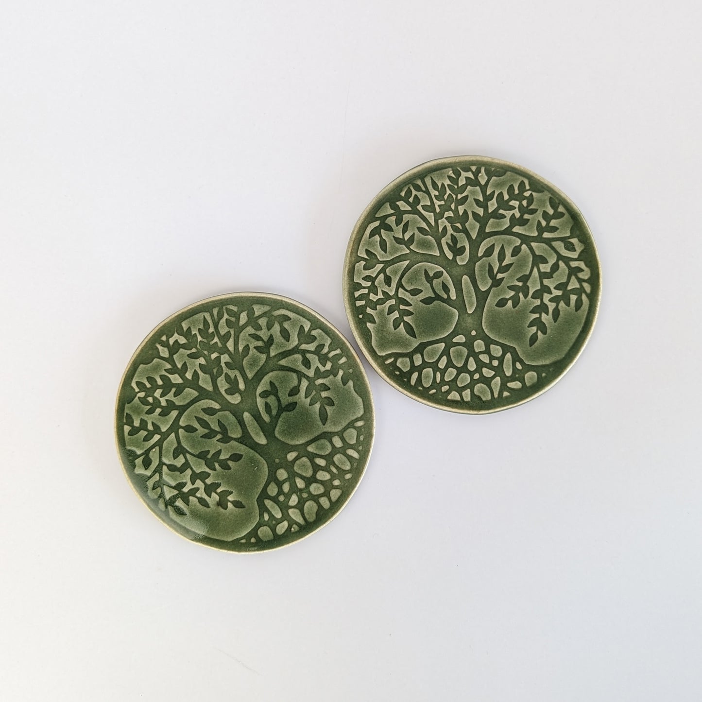 Handcrafted ceramic coasters featuring a vibrant Tree of Life design.