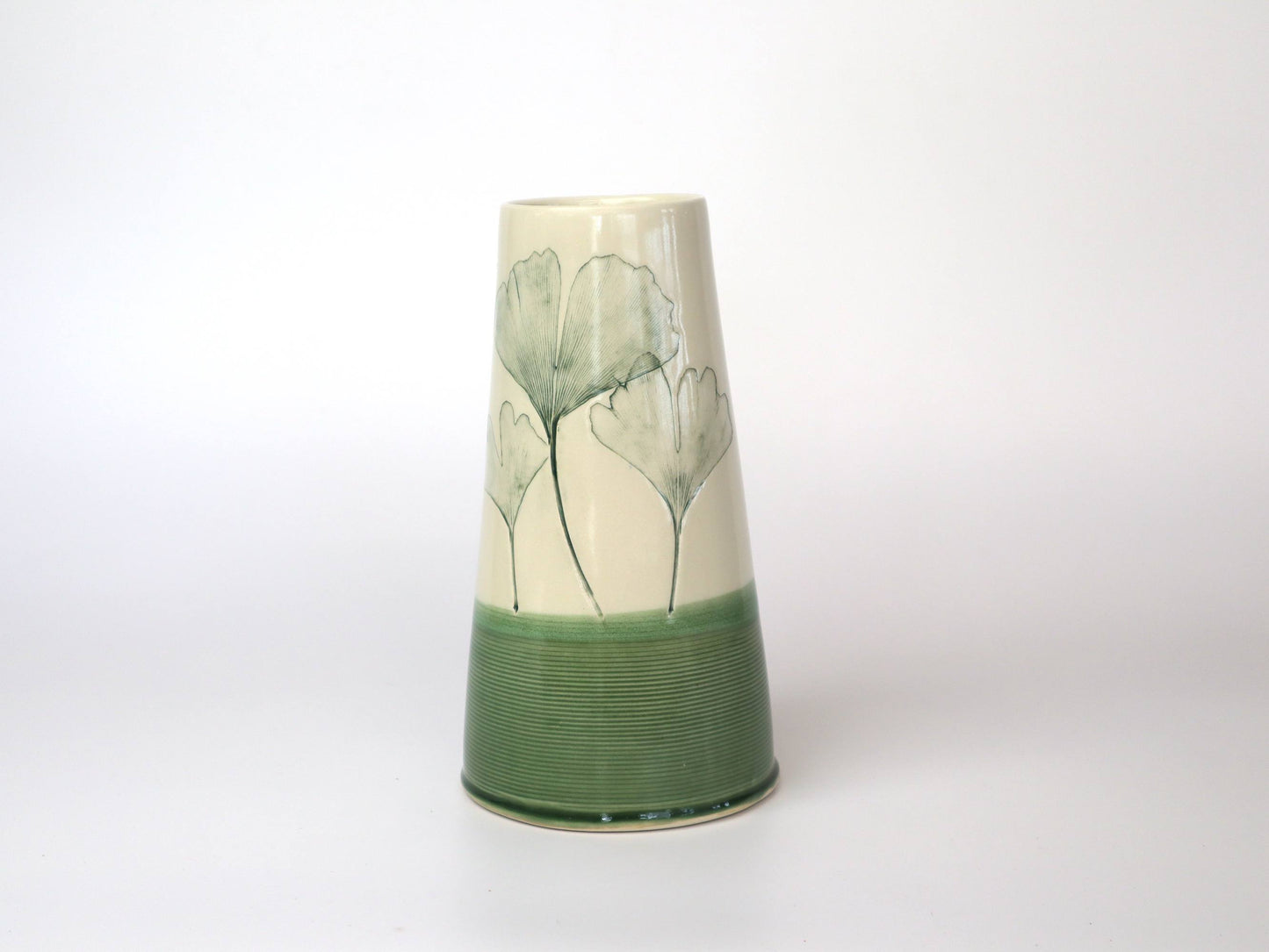 Handmade porcelain vase in calming green, featuring a beautiful Ginkgo leaf pattern, ideal for floral displays.