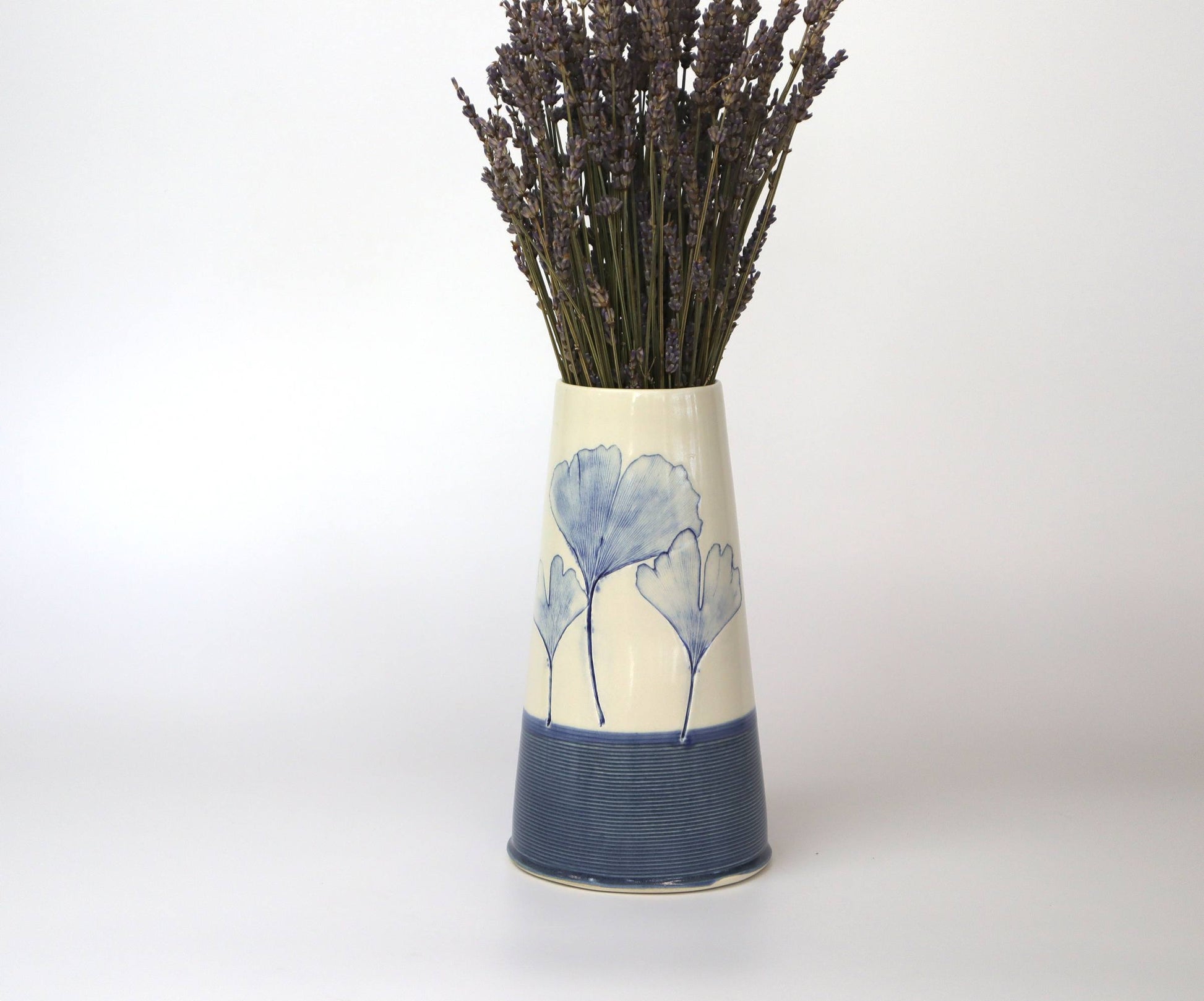 Elegant porcelain vase featuring a delicate Ginkgo Biloba leaf motif, showcasing its unique handmade artistry.