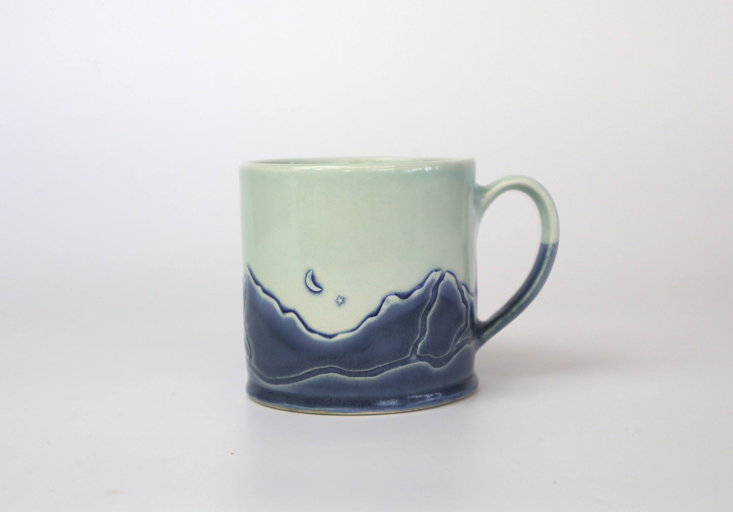 Handmade mug with steam rising from hot beverage, capturing its cozy charm.