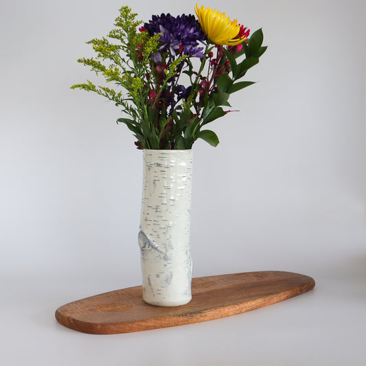 Handcrafted birch ceramic vase filled with vibrant flowers, showcasing its intricate detailing.