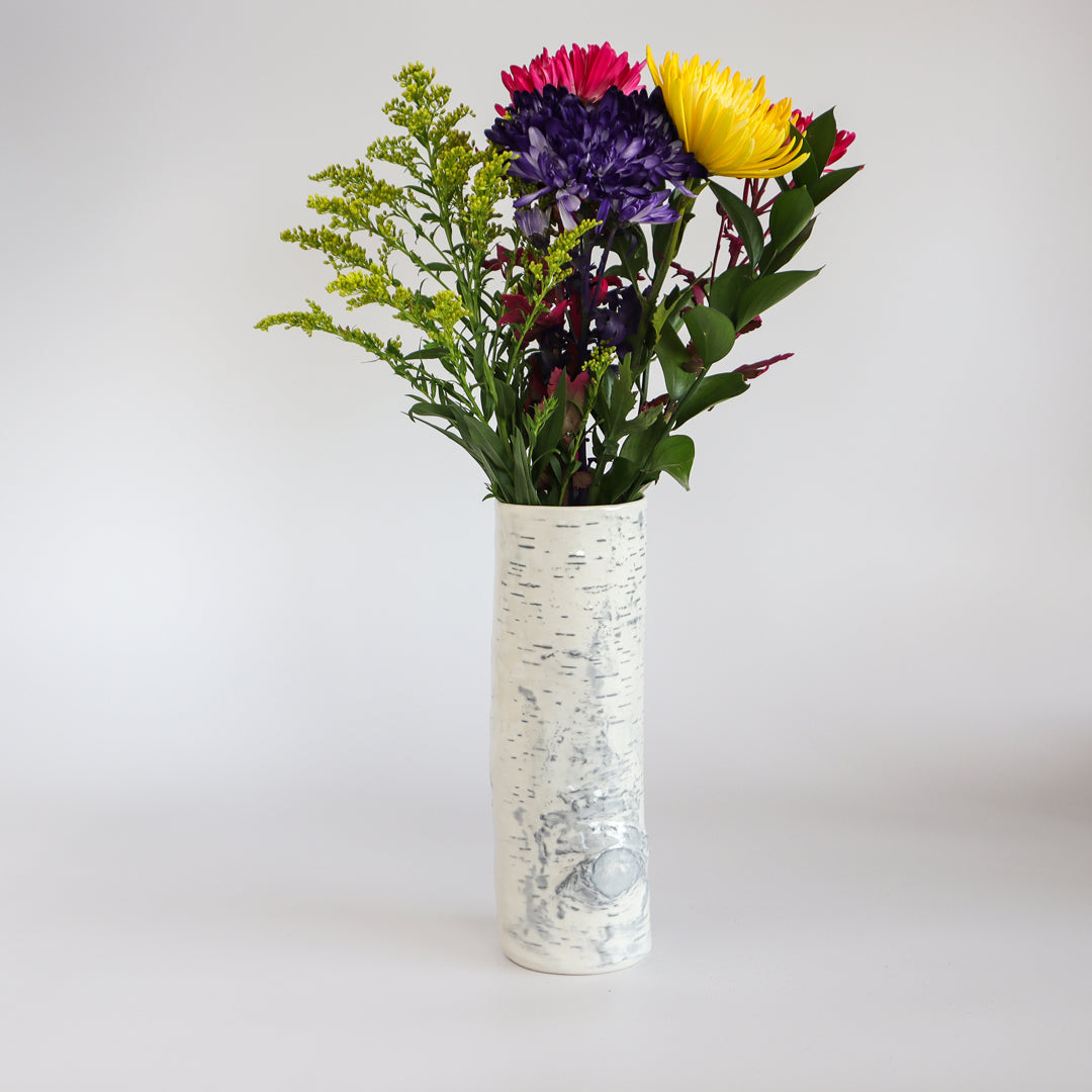 Handcrafted birch ceramic vase displaying a beautiful flower bouquet for a perfect rustic setting.