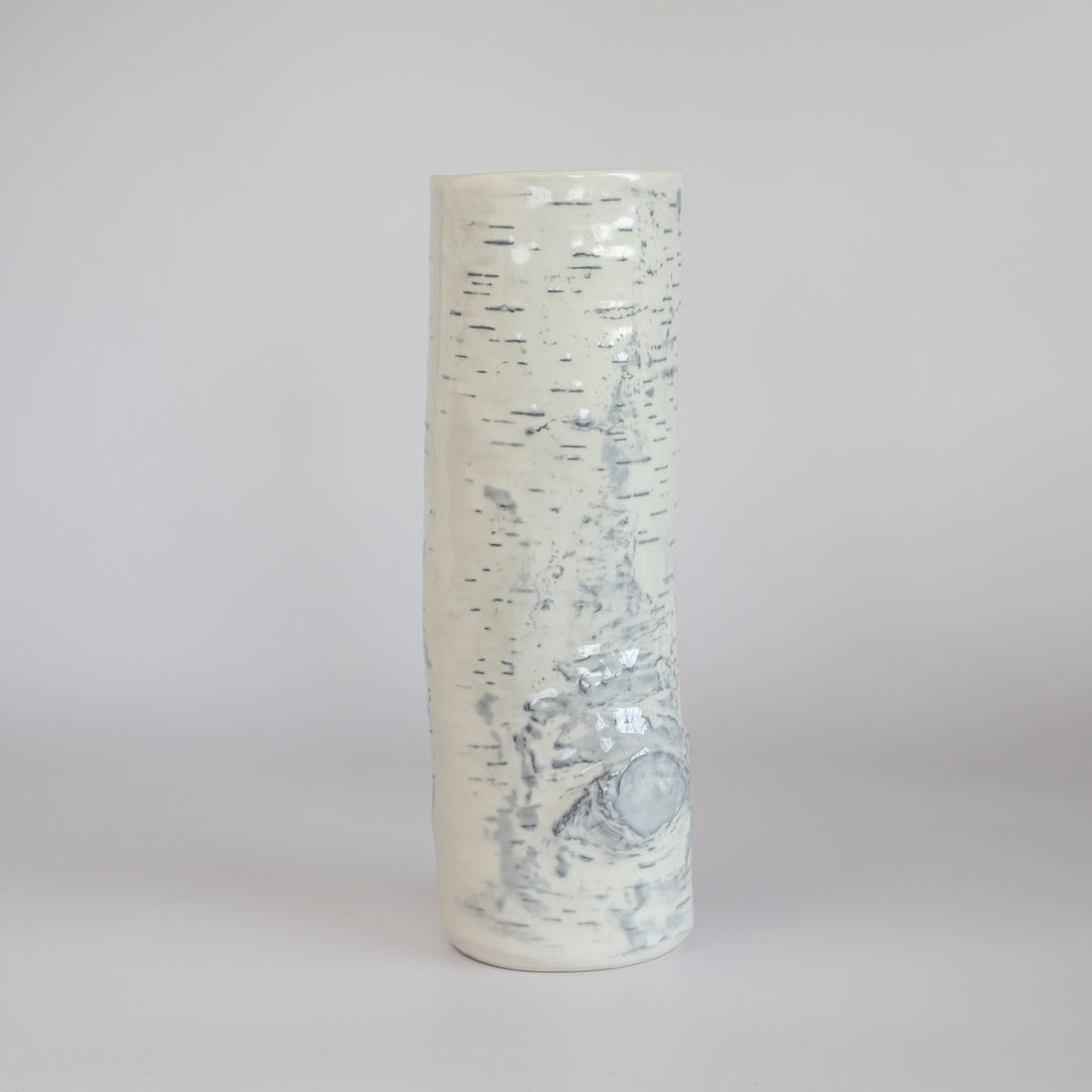 Empty birch ceramic vase against a neutral background, showcasing its sleek silhouette.